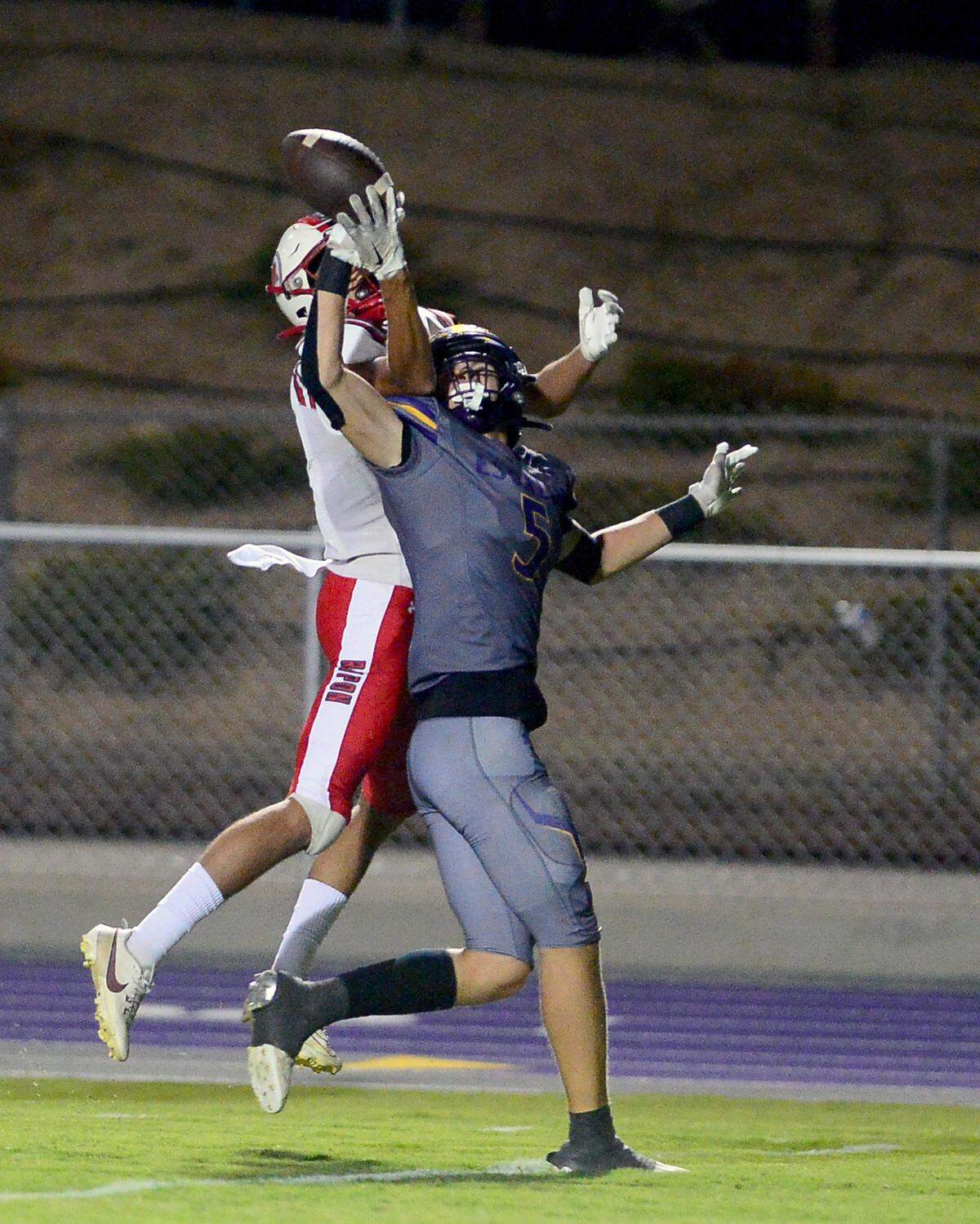 Escalon receiver Sam Jimenez (5) deflects a pass  during a game between Escalon High School and Ripon High School in Escalon, California on October 20, 2023. 