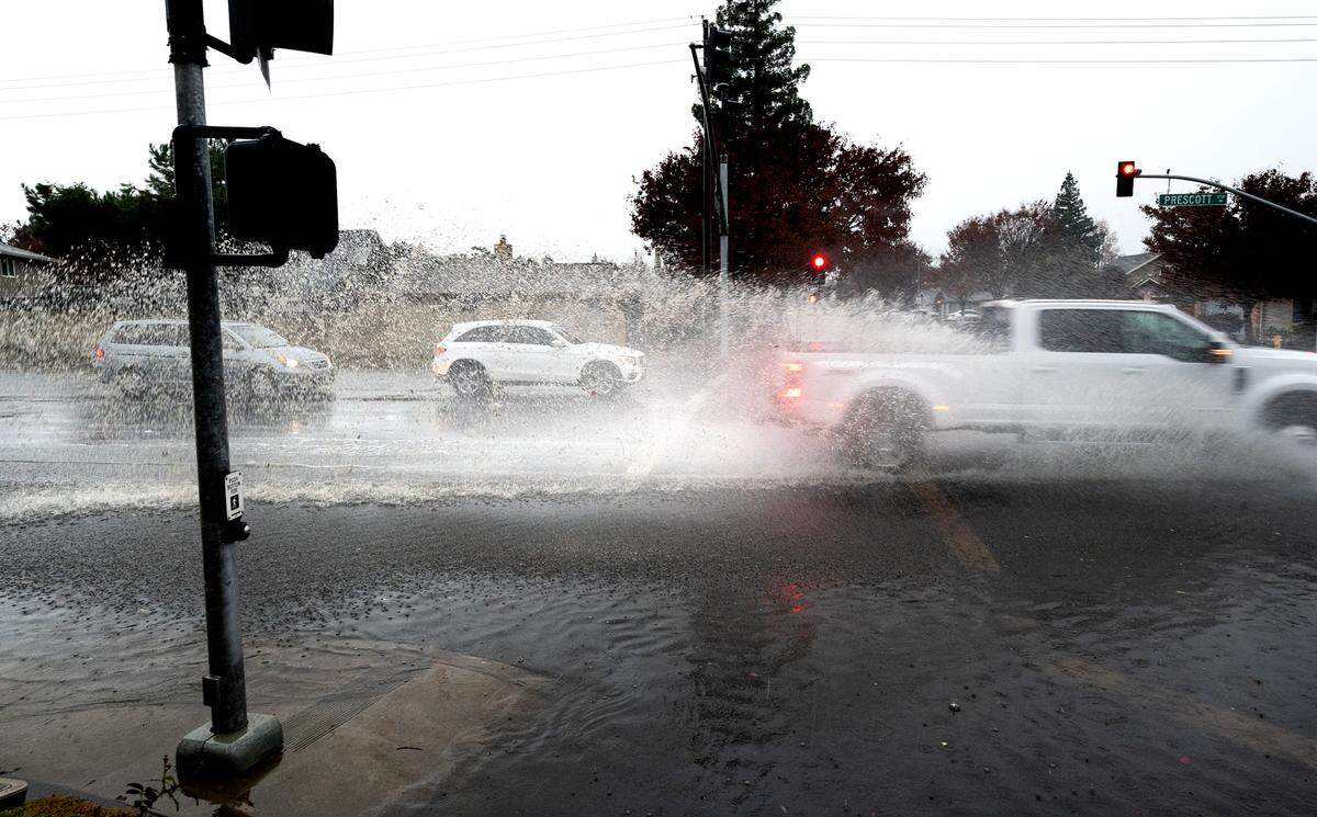 Motorists drive through standing water on Prescott Road in Modesto, Calif., Wednesday, Dec. 20, 2023. 