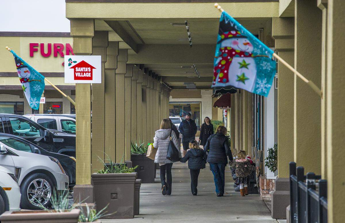 Shoppers at McHenry Village were out to find last minute gifts as Christmas closes in, during another chilly and cloudy day, on Monday, Dec. 23, 2019, in Modesto, California.