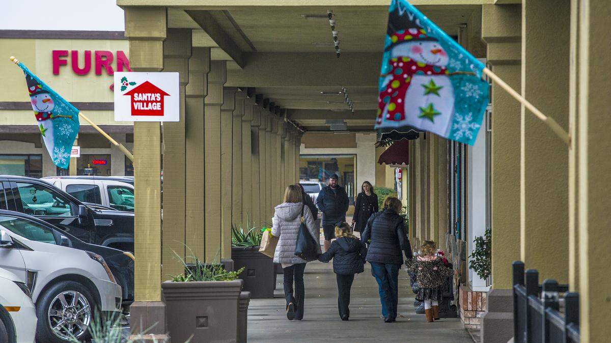 Shoppers at McHenry Village were out to find last minute gifts as Christmas closes in, during another chilly and cloudy day, on Monday, Dec. 23, 2019, in Modesto, California.
