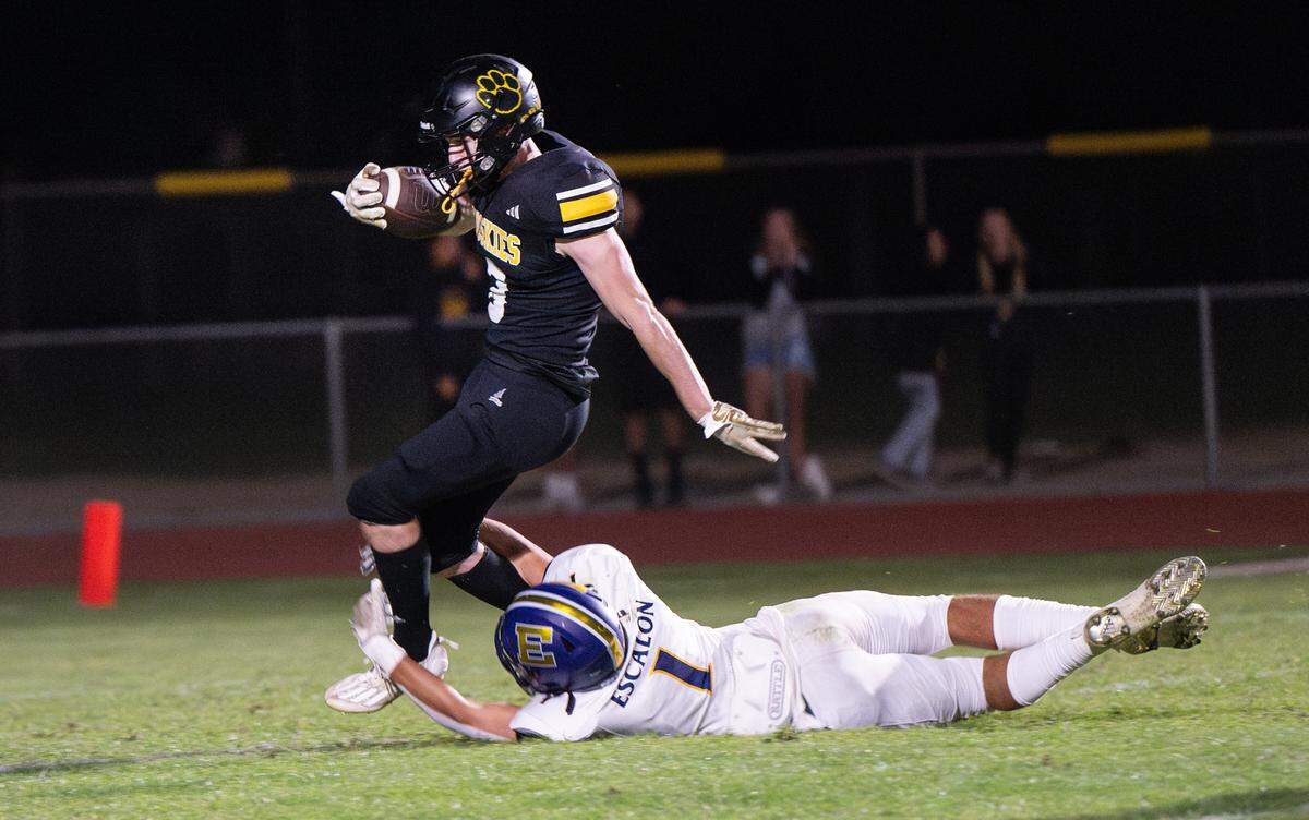Escalon’s Logan Huebner makes an open field tackle on Hughson’s Ben Lighthall during a kick return at Hughson High School in Hughson, Calif., Friday, Sept. 29, 2023.
