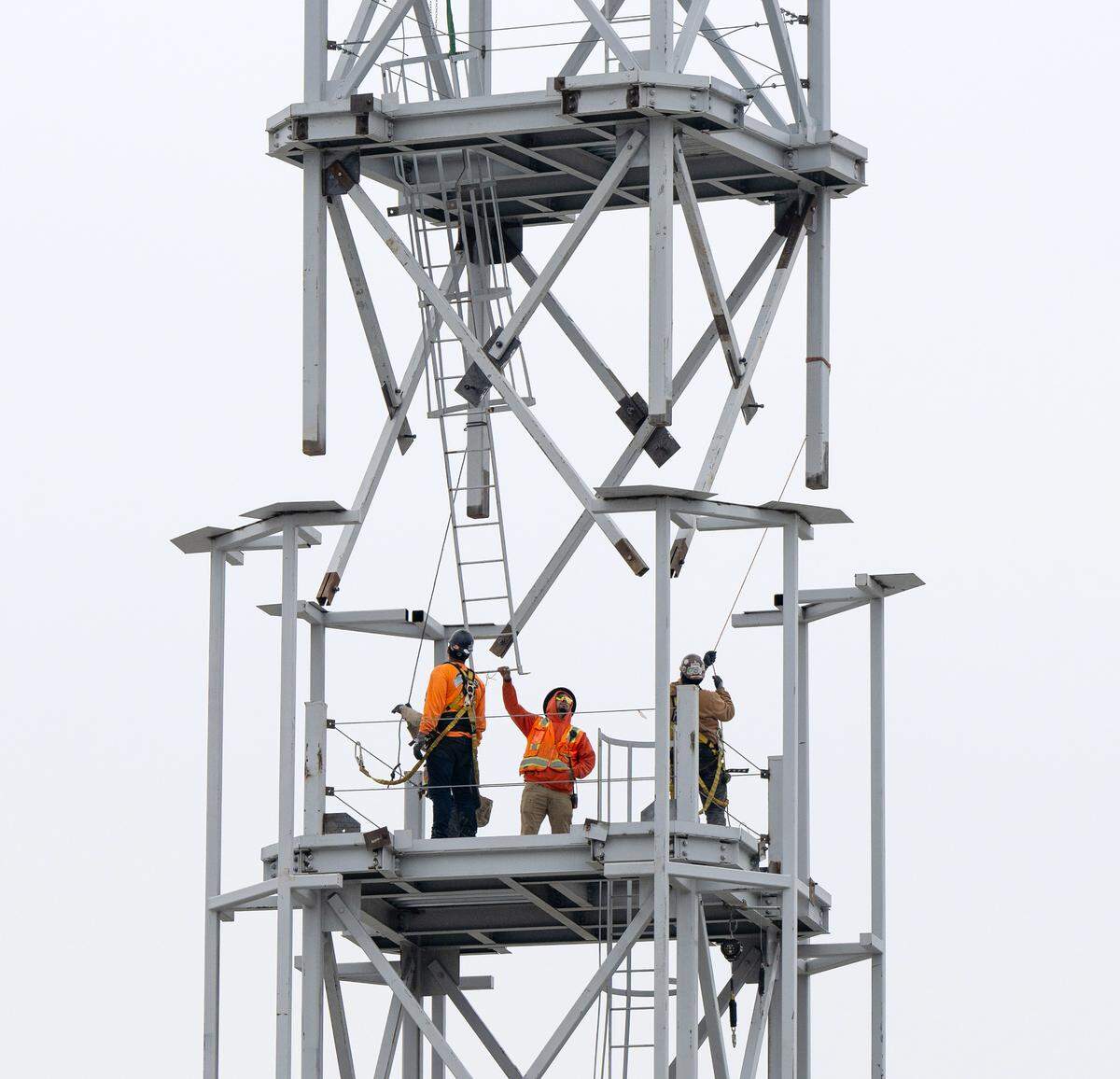A crew places the final section of the tower at the Church of Jesus Christ of Latter-day Saints new temple on Dale Road in Modesto, Thursday, Dec. 19, 2024.