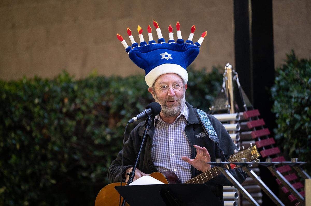 Congregation Beth Shalom Rabbi Shalom Bochner leads the lighting of the menorah on the third day of Hanukkah outside the Gallo Center for the Arts in Modesto, Calif., Tuesday, Dec. 20, 2022.