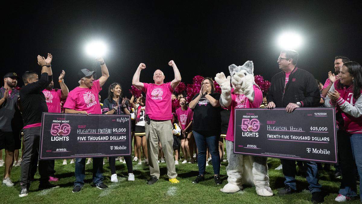 Teachers and administrators cheer the $30,000 prize from T-Mobile during Friday’s game at Hughson High School in Hughson, Friday, Oct. 11, 2024.
