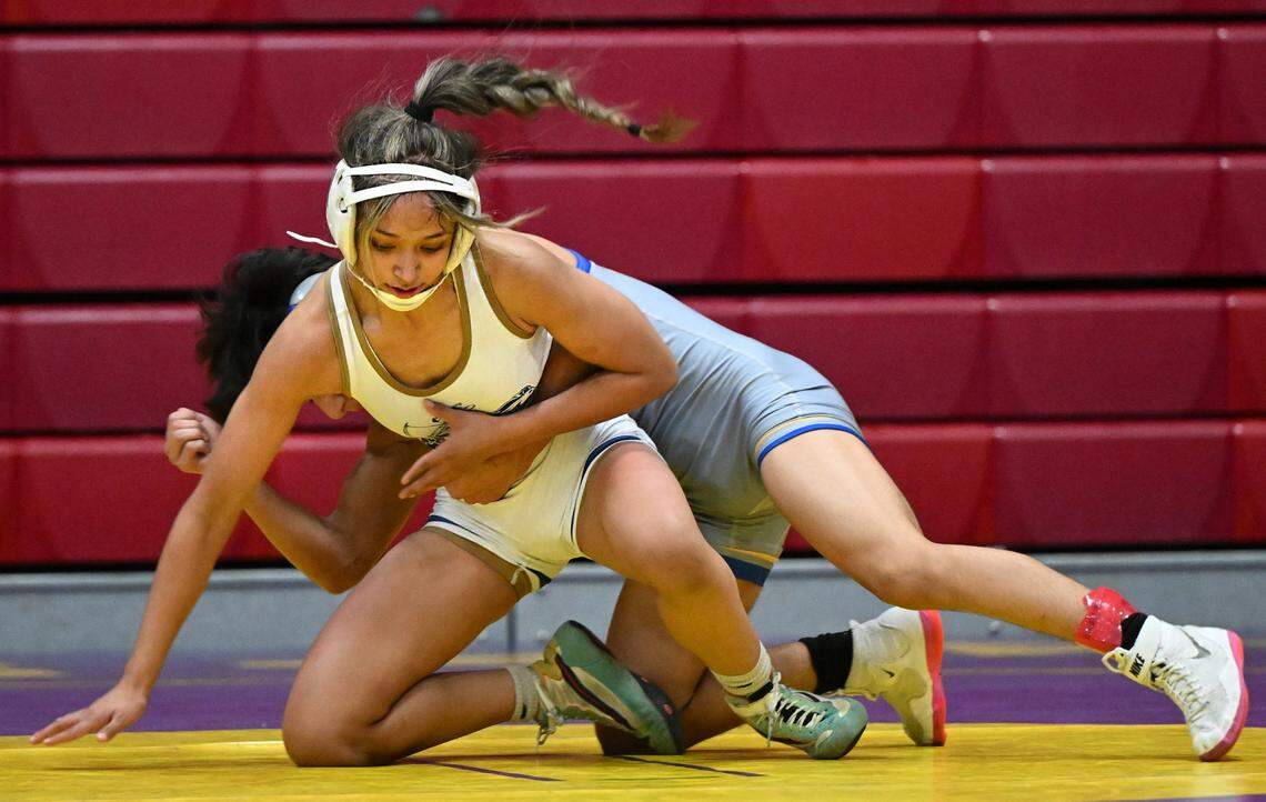 Central Catholic’s Aleena Nguyen grapples with a Wood High wrestler during the Sac-Joaquin Section team wrestling duals at Lincoln High School in Stockton, Calif., Saturday, Jan. 27, 2024.