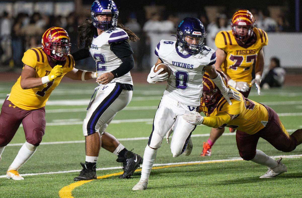 Johansen’s Tek Garcia slips past a Los Banos defender during the Western Athletic Conference game at Johansen High School in Modesto, Calif., Friday, Oct. 6, 2023.