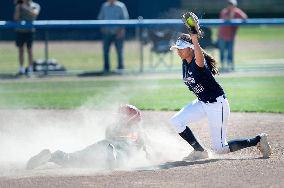 Central Catholic shortstop Taryn Calderon tags out Oakdale’s Morgan Merzon at second base during the Valley Oak League game at Central Catholic High School in Modesto, Calif., Tuesday, April 25, 2023.