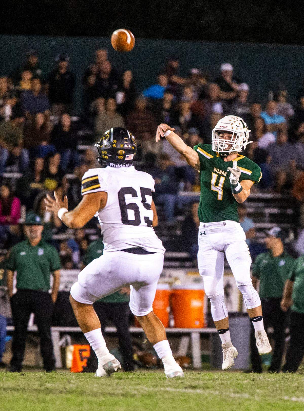 Merek Ellerd, 4, of Hilmar High throws a pass over Dominic Aguiar, 65, of Hughson during Friday Oct. 20, 2023 nights game at Hilmar.