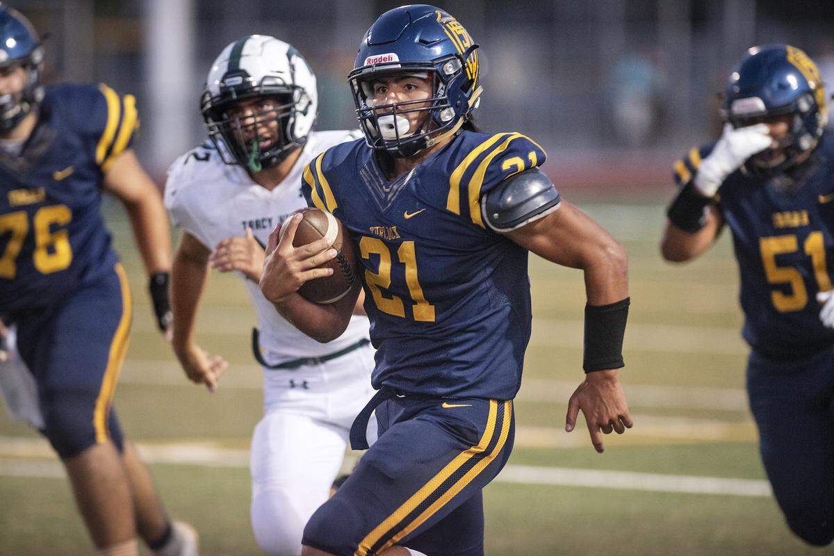 Turlock’s Anthony Frias runs the ball during the non-conference game with Tracy at Turlock High School in Turlock, Calif., Sept. 5, 2019. Turlock won the game 43-14.