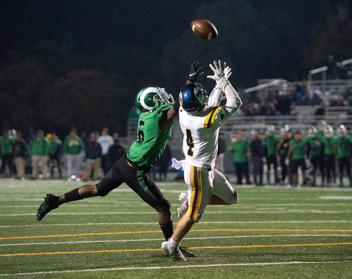 Turlock’s Peter Mello makes a touchdown catch past St. Mary’s Joshua Watkins in the final two minutes of the CIF Sac-Joaquin Section Division I playoff game at St. Marys High School in Stockton, Calif., Friday, Nov. 11, 2022. After Mello’s touchdown, Turlock scored a two-point conversion to go ahead and win the game 51-50.