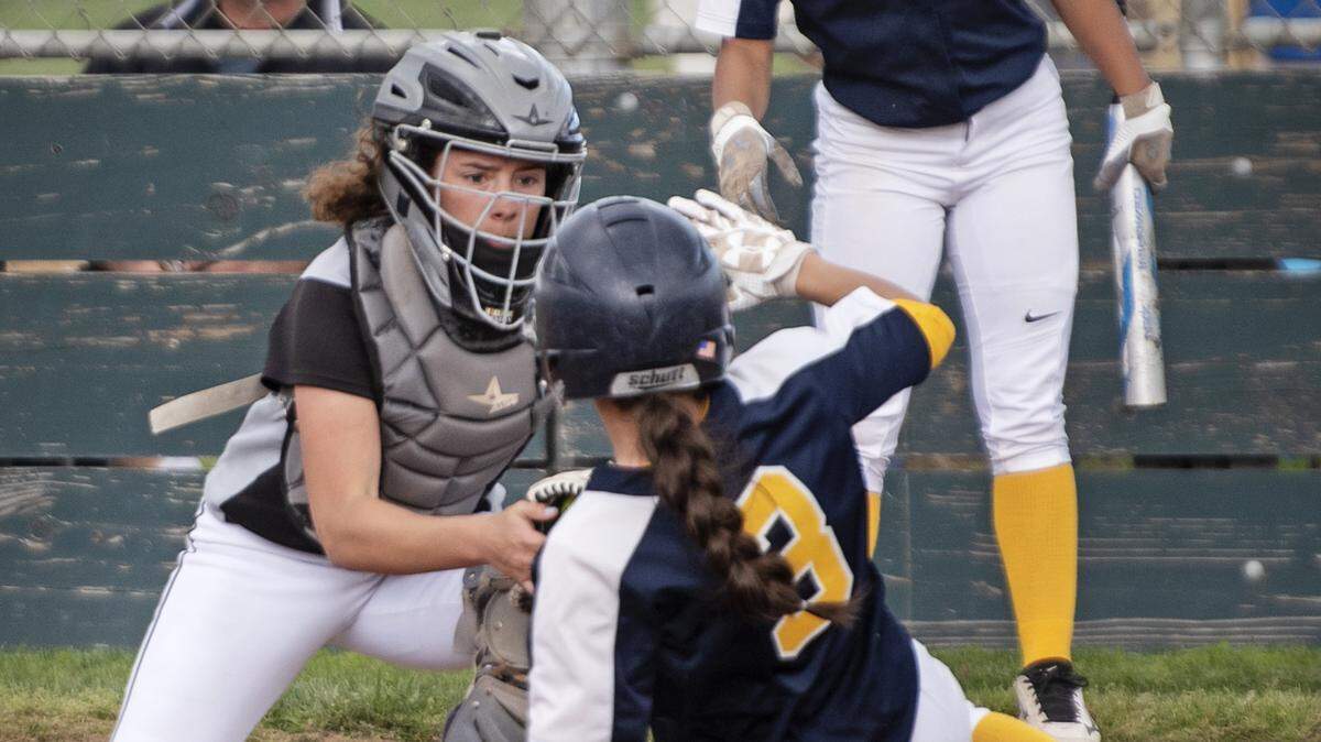Enochs catcher Morgan Leonard tags out Turlock runner Nataly Jimenez during the Central California Athletic League game at Enochs High School in Modesto, Calif., Thursday, March 28, 2019.
