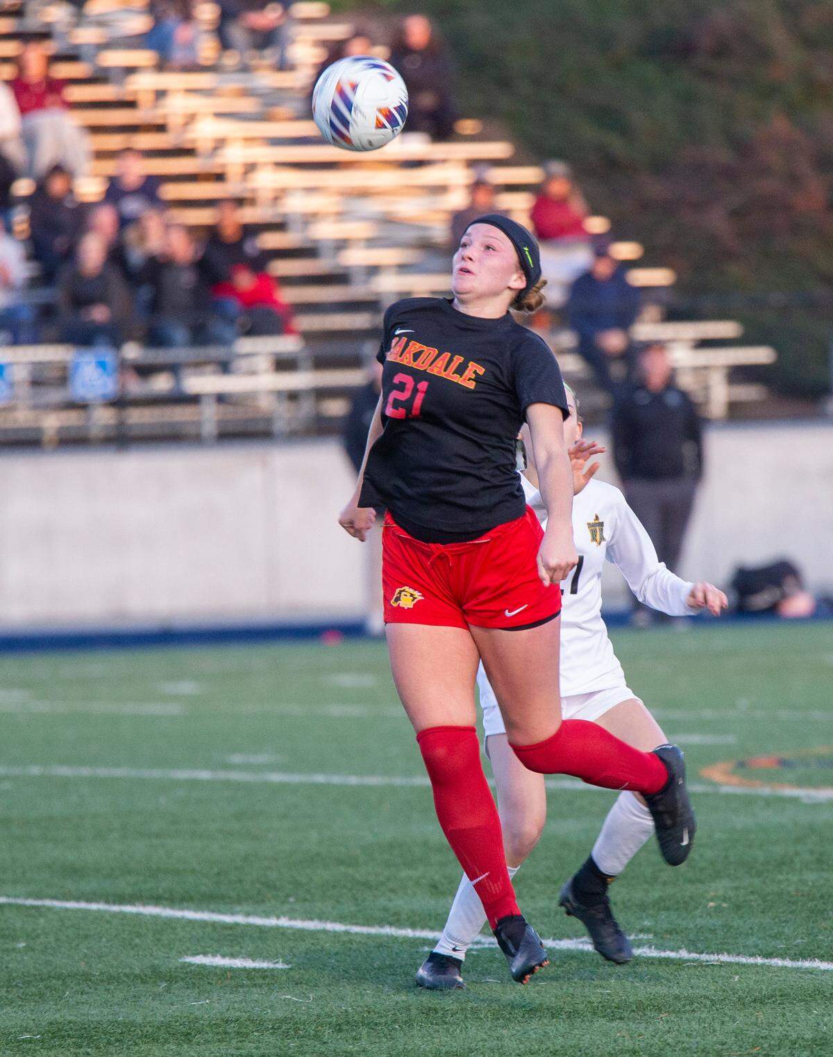 Oakdale High’s Kyleigh Melconian, 21, heads the ball during the Sac-Joaquin Section Division III Section Championship match against Rio Americano Thursday Feb. 22, 2024 at Cosumnes River College.