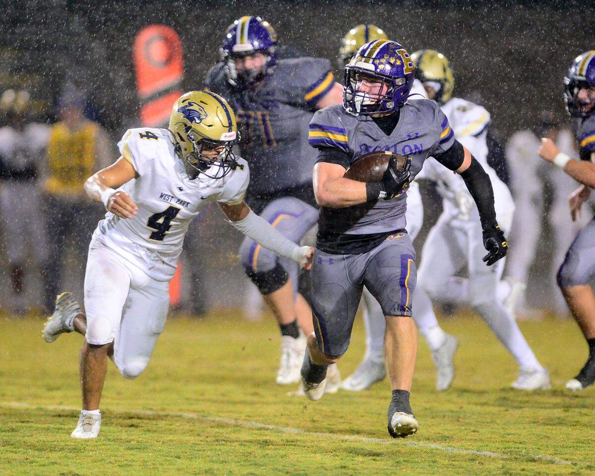 Escalon running back Jamin Miller (26) runs away from a West Park defender during a 2023 CIF San Joaquin Section Division IV football game between Escalon and West Park at Escalon High School in Escalon, California, on Nov. 17, 2023. Escalon won the game 48-28.