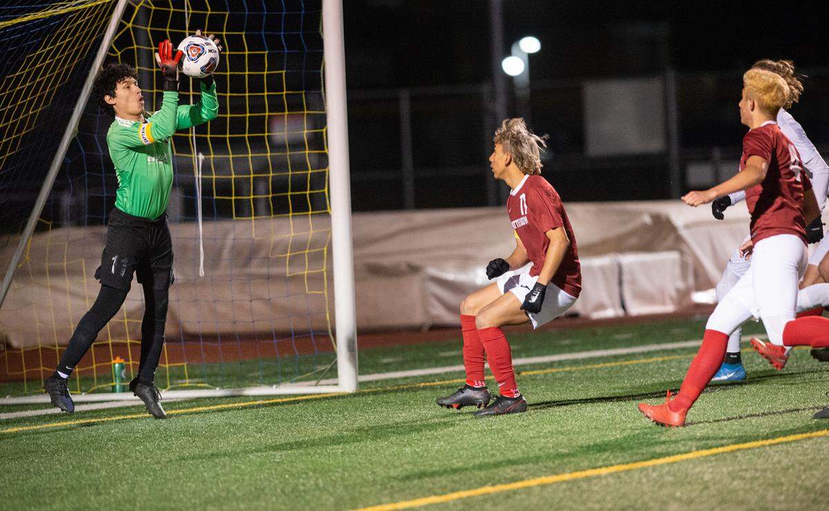 Vista del Lago goalie Jacob Granados stops the ball during the Sac-Joaquin Section Division III title game with Patterson at Turlock High School in Turlock, Calif., on Tuesday, Feb. 22, 2022. Vista del Lago (Folsom) won the championship 2-0.