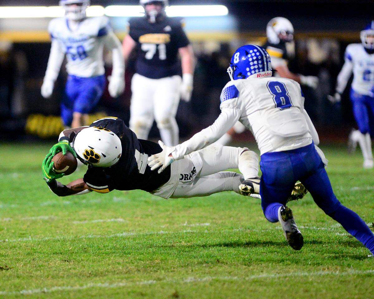Hughson receiver Malakai Sumter (4) dives to make a catch during a 2024 CIF Sac-Joaquin Section Division V Playoff game between Hughson High School and El Dorado High School at Hughson High School in Hughson California on November 15, 2024. Hughson won the game 28-6.