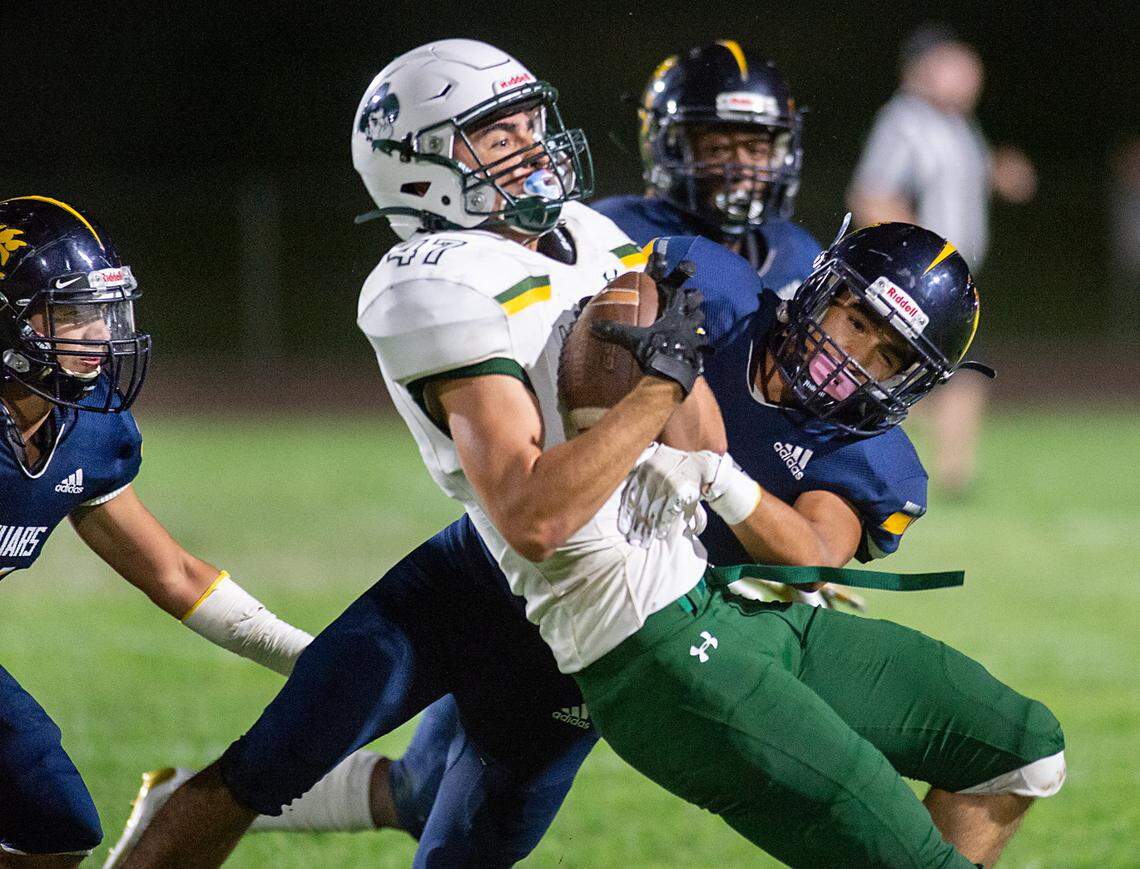 Gregori’s Guillermo Perez tackles Livermore’s Maxwell Serpa during the non-league game in Salida, Calif., on Friday, Sept. 10, 2021.