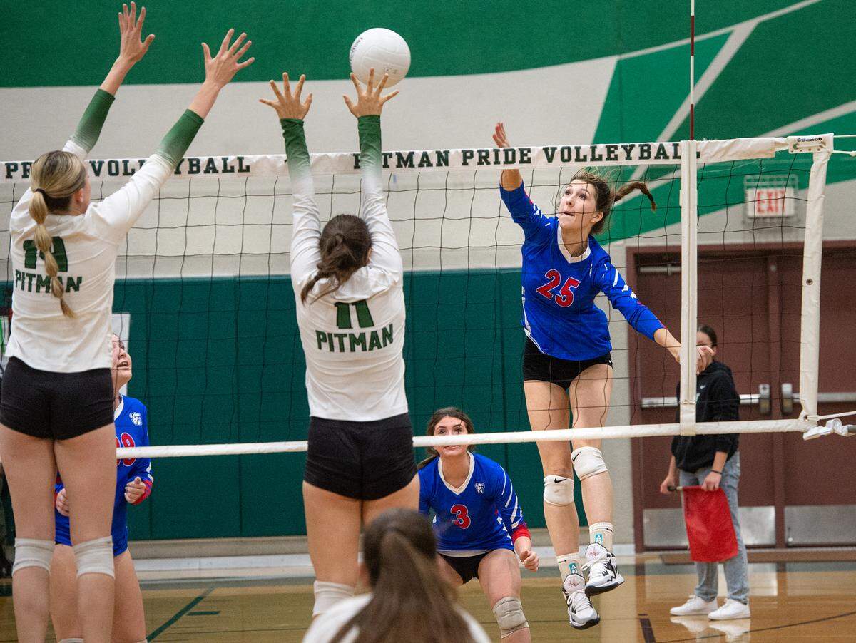 Folsom’s Addie Kannegeisser spikes a ball past Pitman defenders Ella Sniezek (11) and Lauren Hamilton (14) during the CIF Sac-Joaquin Girls Volleyball Division I playoff match at Pitman High School in Turlock, Calif., Thursday, Oct. 27, 2022. Pitman won the match 3-1.