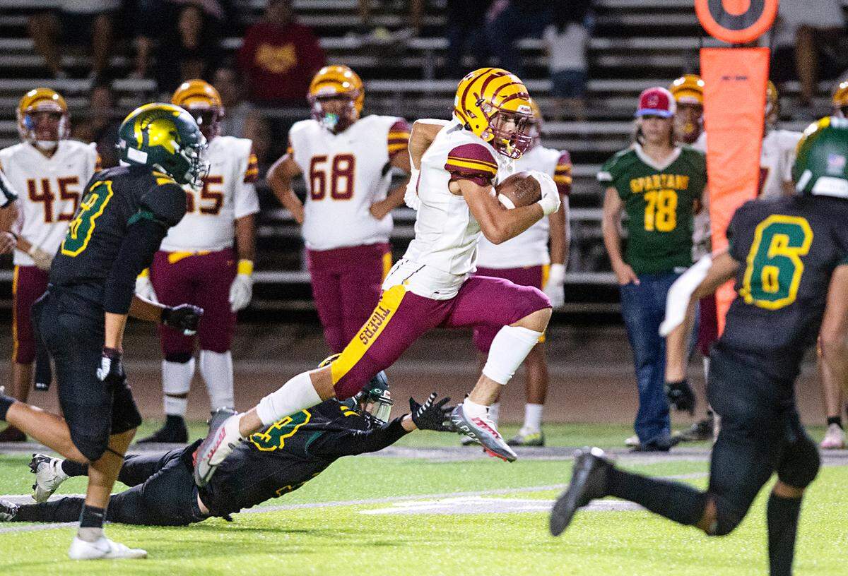 Los Banos runner Mark Carreiro breaks out for a 71-yard touchdown run during a Western Athletic Conference game with Davis at Downey High School in Modesto, Calif., on Friday, September 23, 2022.