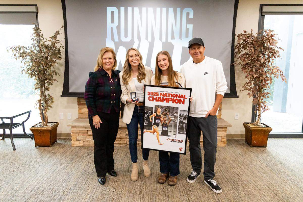 Stanislaus State junior distance runner Annie Wild was honored on the Turlock, Calif. campus, receiving her NCAA Division II national championship ring after claiming the title in the mile at the 2025 NCAA D-II Indoor Track & Field National Championships as a sophomore. She is pictured with President Britt Rios-Ellis, assistant coach Courtney Heiner and head coach Darren Holman.