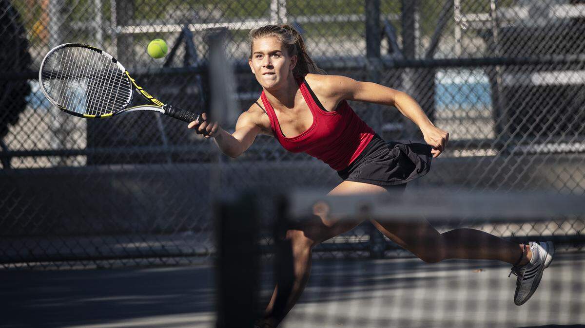 Modesto No. 1 singles player Milla Skowron reaches for a ball hit by Enochs’ Alyssa Tay at Enochs High School in Modesto, Calif., Tuesday, Oct. 1, 2019.