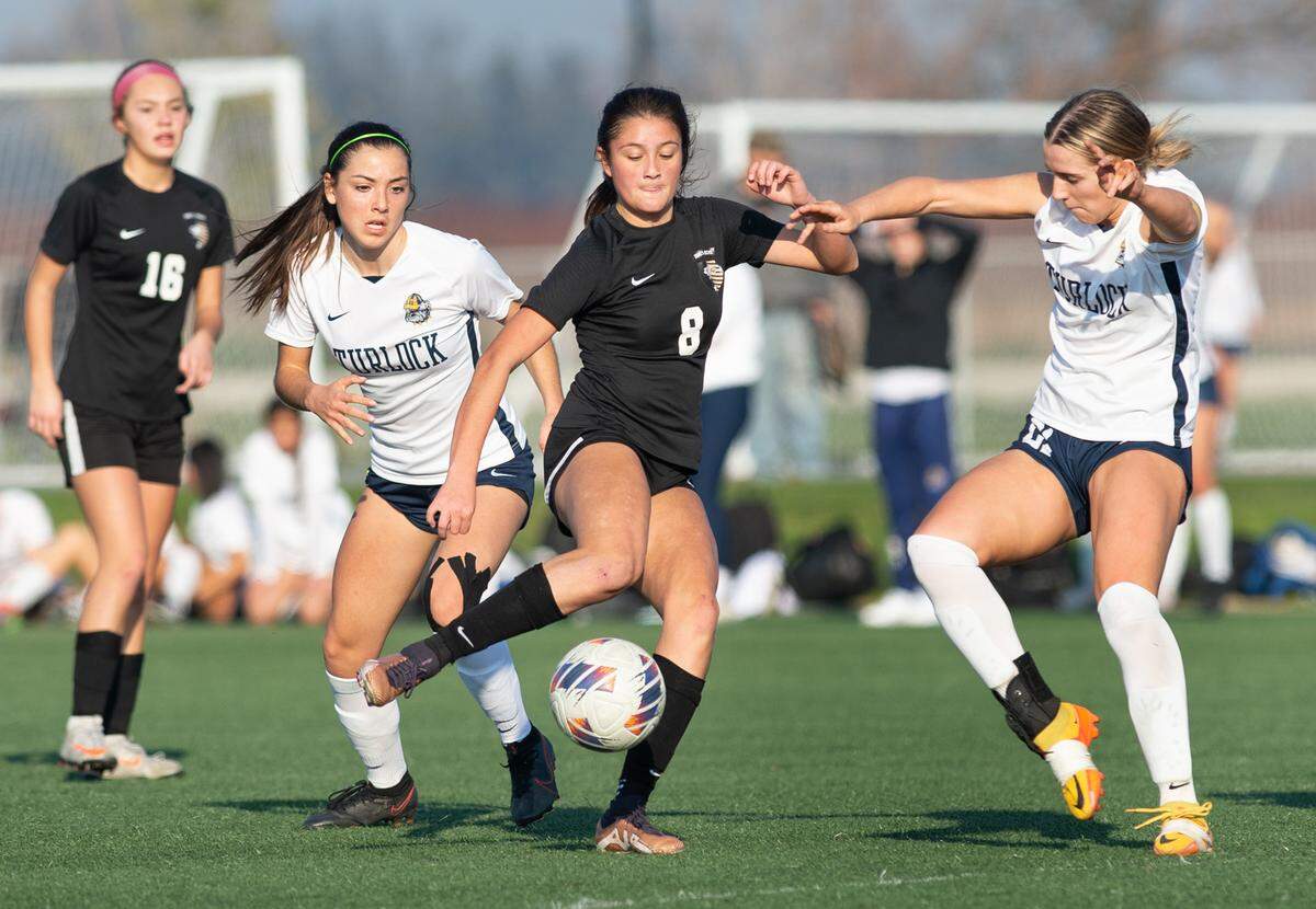 Enochs’ Hayden Crotty-Romero takes a shot on goal as Turlock’s (23) defends during a Central California Athletic League game at Mary Grogan Park in Modesto, Calif., Wednesday, Jan. 25, 2023.
