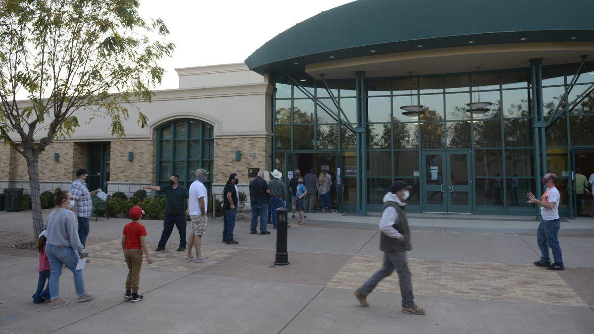 Voters wait outside the Gene Bianchi Community Center in Oakdale, California, on Tuesday, Nov. 3, 2020.
