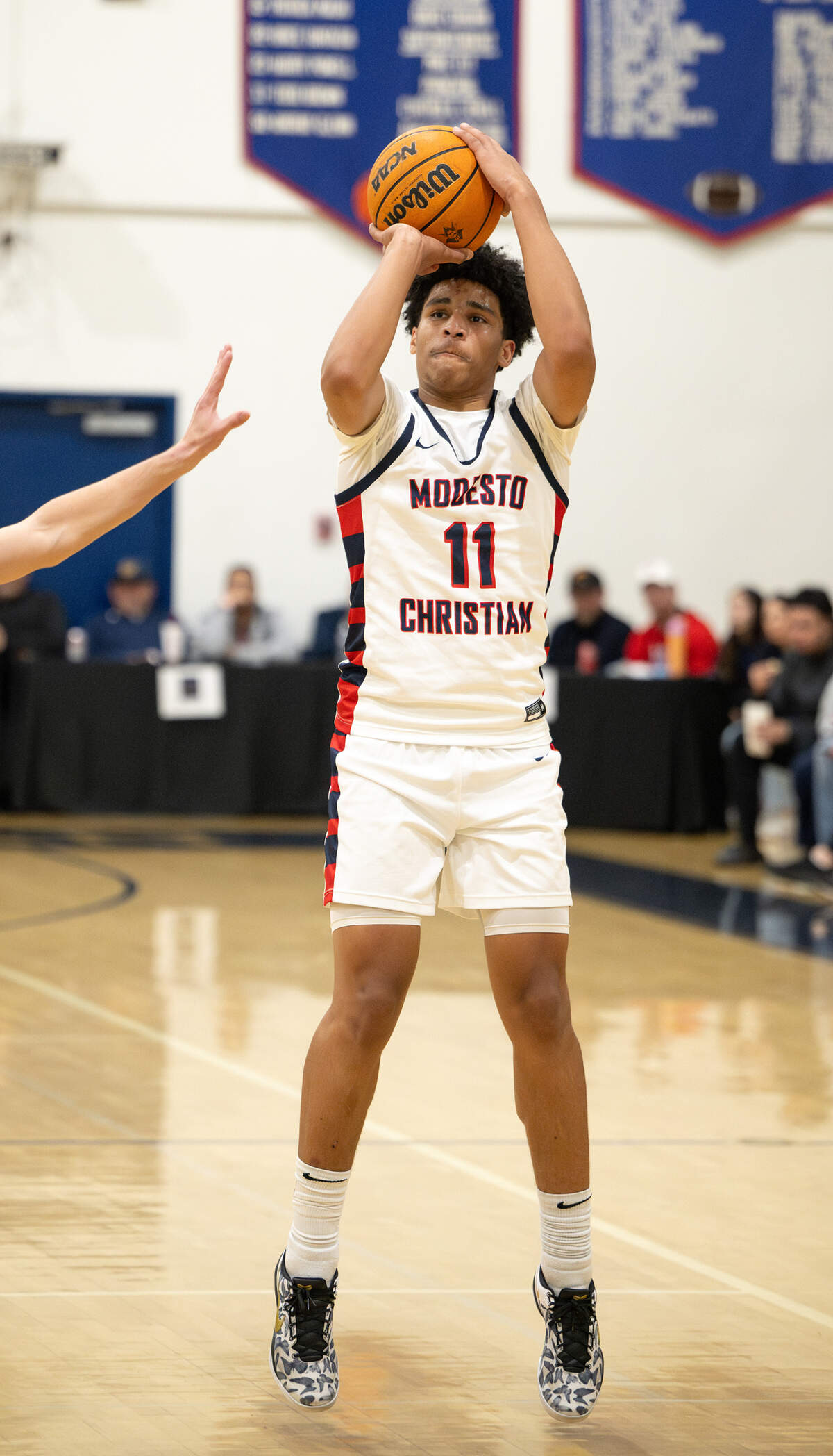 Modesto Christian’s Gavin Sykes shoots a jump shot during the Holiday Hoop Classic championship game with Buchanan at Modesto Christian High School in Salida, Monday, Dec. 30, 2024.