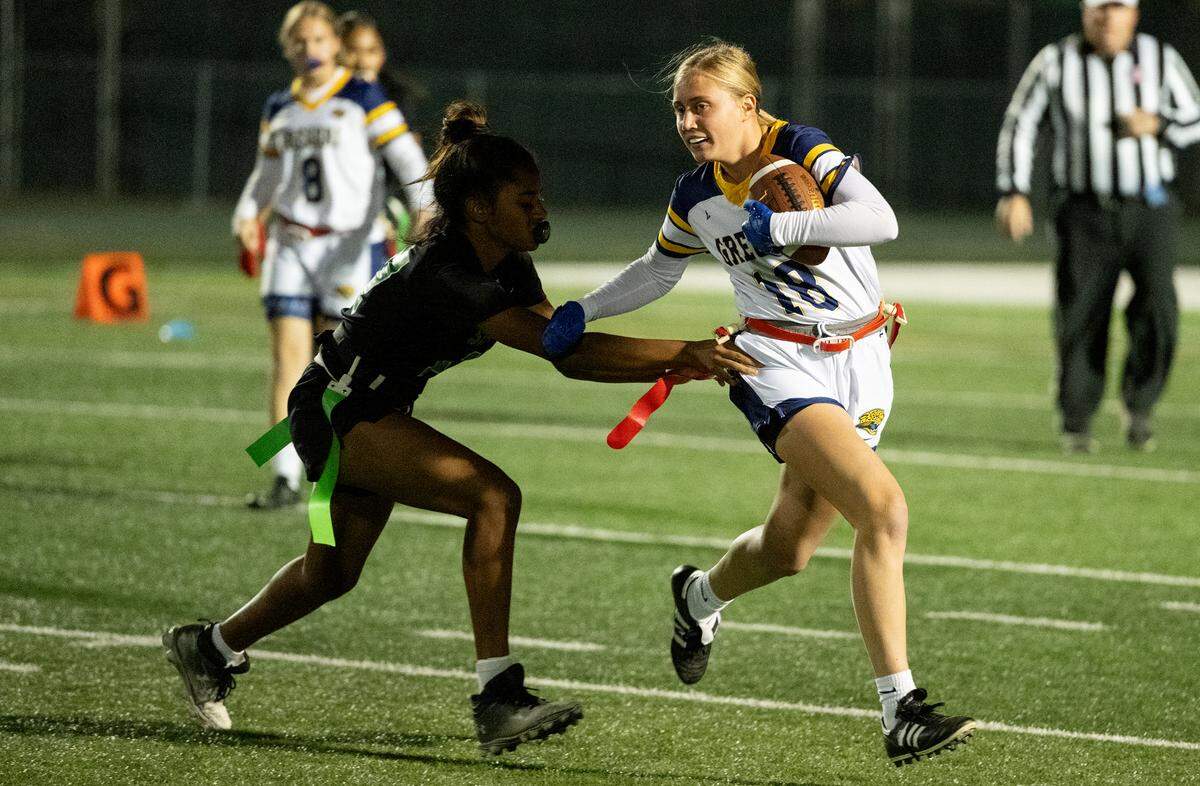 Gregori’s Rachel Warter runs the ball after a catch as St. Mary’s Khairun Burkhalter reaches for the flag during the Sac-Joaquin Section playoff flag football game at St. Mary’s High School in Stockton, Tuesday, Oct. 29, 2024.