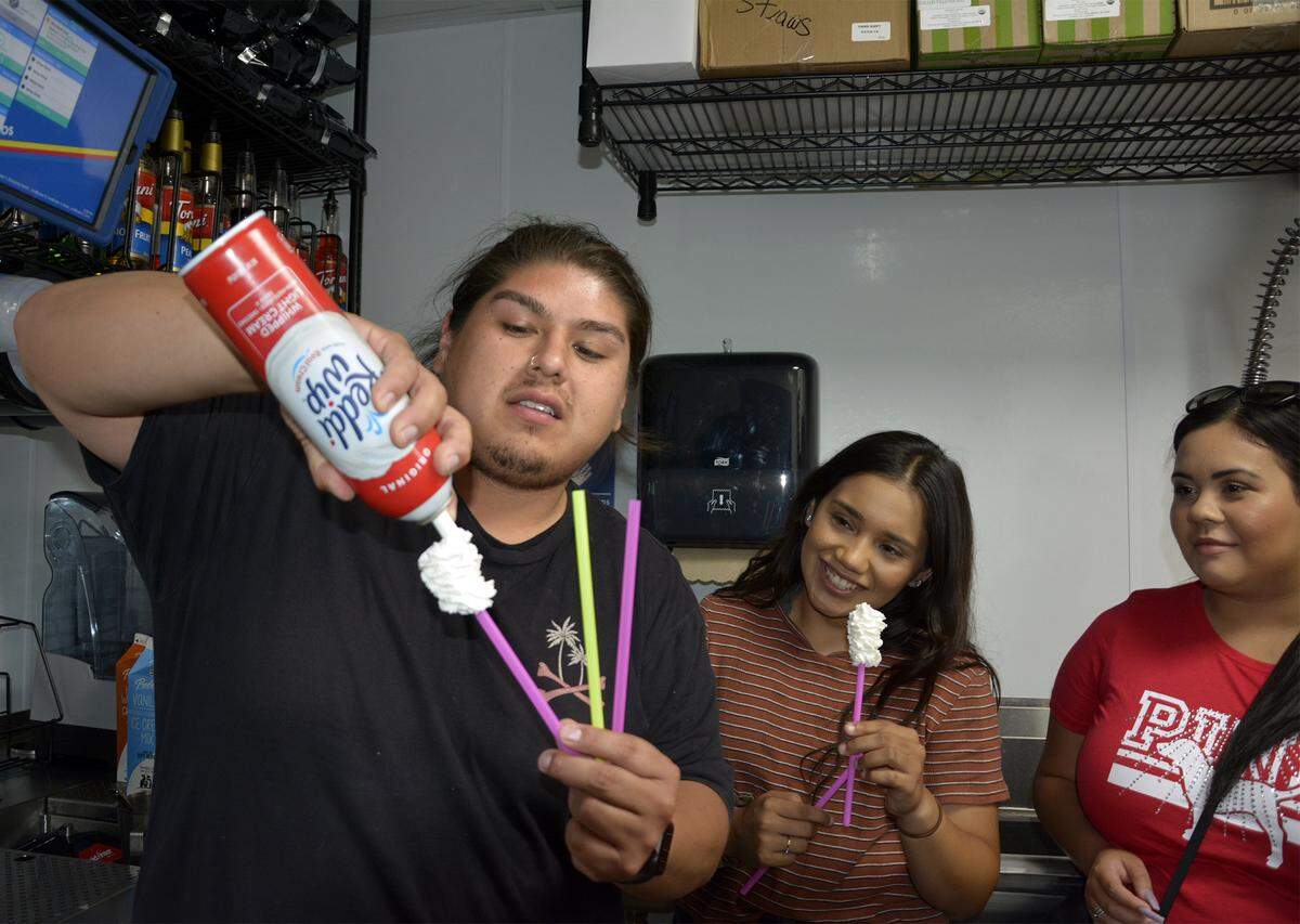 Dutch Bros Coffee trainer Martin Marquez demonstrates how to make “whip sticks” for employees of the new Dutch Bros Coffee drive-up coffee shop in Oakdale, Calif., which opens Friday, Aug. 30, 2019.