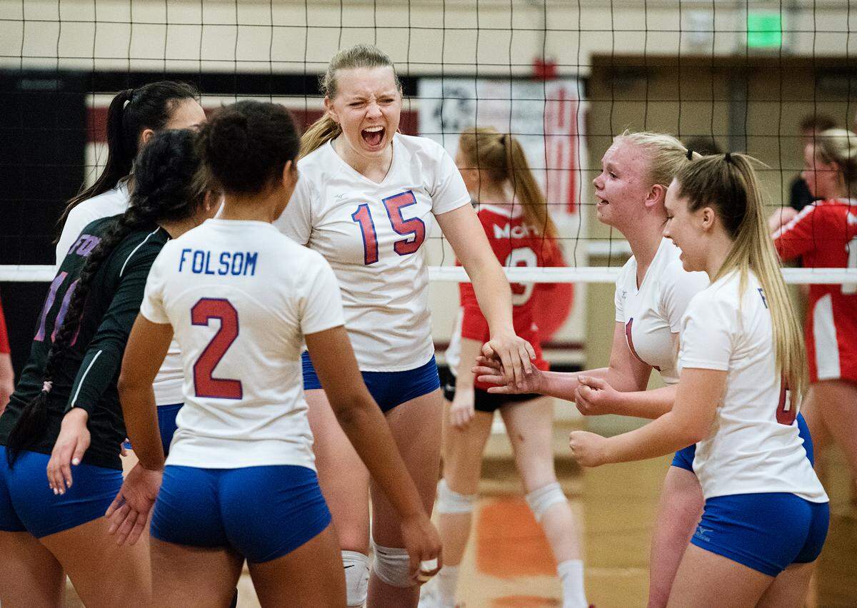 Folsom’s Allison Hakes (15) celebrates a point with teammates during the Sac Joaquin Section playoff game with Modesto at Modesto high School in Modesto, Ca., on Tuesday, Oct. 23, 2018.
