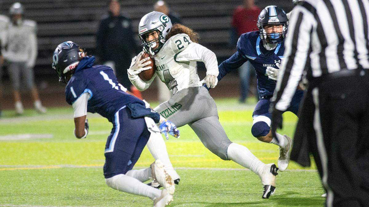 Granite Bay’s Isaiah Ene runs the ball during the CIF Sac-Joaquin Section Division II playoff game at Downey High School in Modesto, Calif., Friday, Nov.11, 2022.