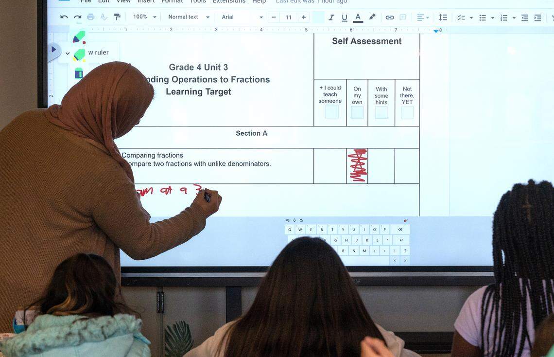 Fourth grade teacher Heba Morad explains the self assessment worksheet after a math lesson at Walter White Elementary School in Ceres, Calif., Wednesday, Dec. 14, 2022.