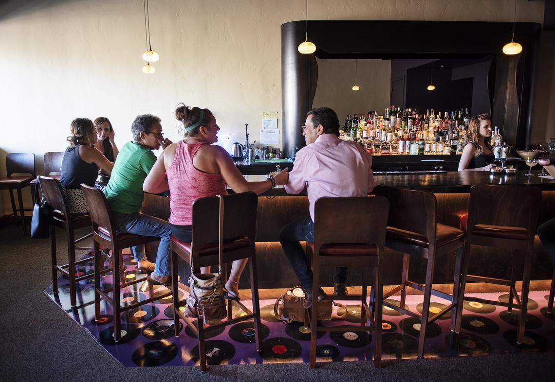 People enjoy a drink at Lo-Fi craft cocktail bar in Modesto, Calif., Wednesday, July 31, 2019.