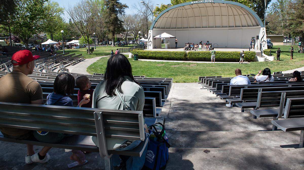 Visitors watch a game of musical chairs at Mancini Bowl during Earth Day celebrations at Graceada Park in Modesto, Calif., Saturday, April 22, 2023.