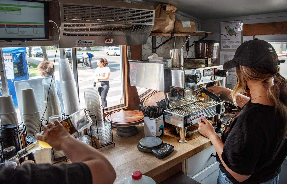 Emilee Hutzler makes a coffee drink inside the Culture Coffee Bar at Thursday’s farmers market in Modesto, Calif., on Aug. 12, 2021.