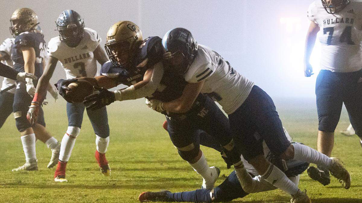 Central Catholic’s Aiden Taylor reaches across the goal line for a touchdown in the first half of the CIF Division II Northern California Regional Championship game with Bullard (Fresno) at Central Catholic High School in Modesto, Calif., Dec. 3, 2021. Central Catholic won the game 44-41.