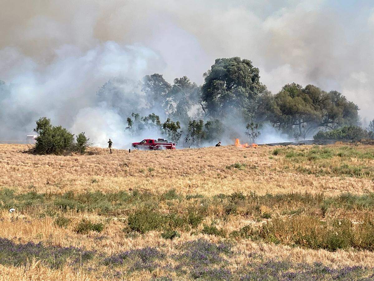 Firefighters from across Stanislaus County are battling a vegetation fire in Modesto’s airport district Monday afternoon. May 2, 2022