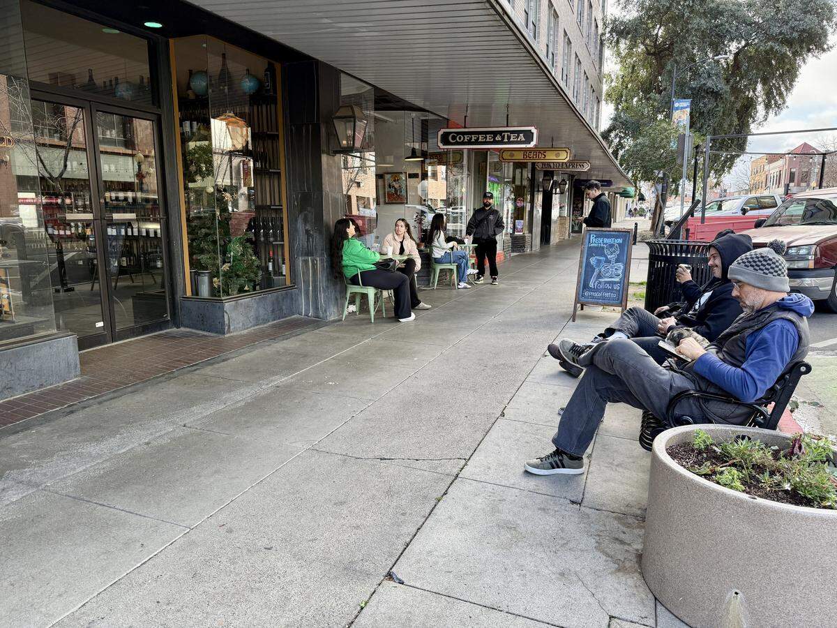 Customers sit outside of Preservation Coffee & Tea in Modesto on Friday, Dec. 26, 2025.