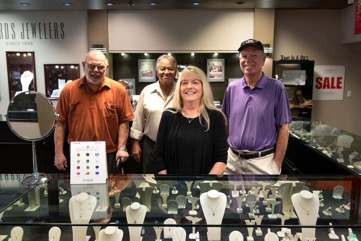 Edwards Jewelers staff Nancy Culbertson, middle, Bill Webb, left Dennis Culbertson, right, and Bill Rosario, second left, in Modesto, Calif., Wednesday, Nov. 9, 2022. The store is closing at the end of the year after 74 years in business.