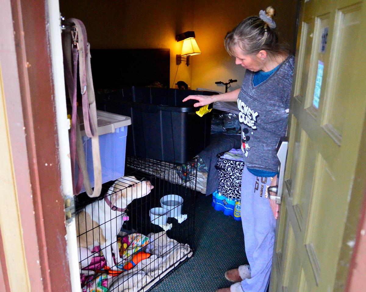 Rose Jones looks at her dog April while she packs up all her belongings after being evicted by the Budgetel Inn & Suites on McHenry ave due to the business’s closure on January 26, 2019 in Modesto California.