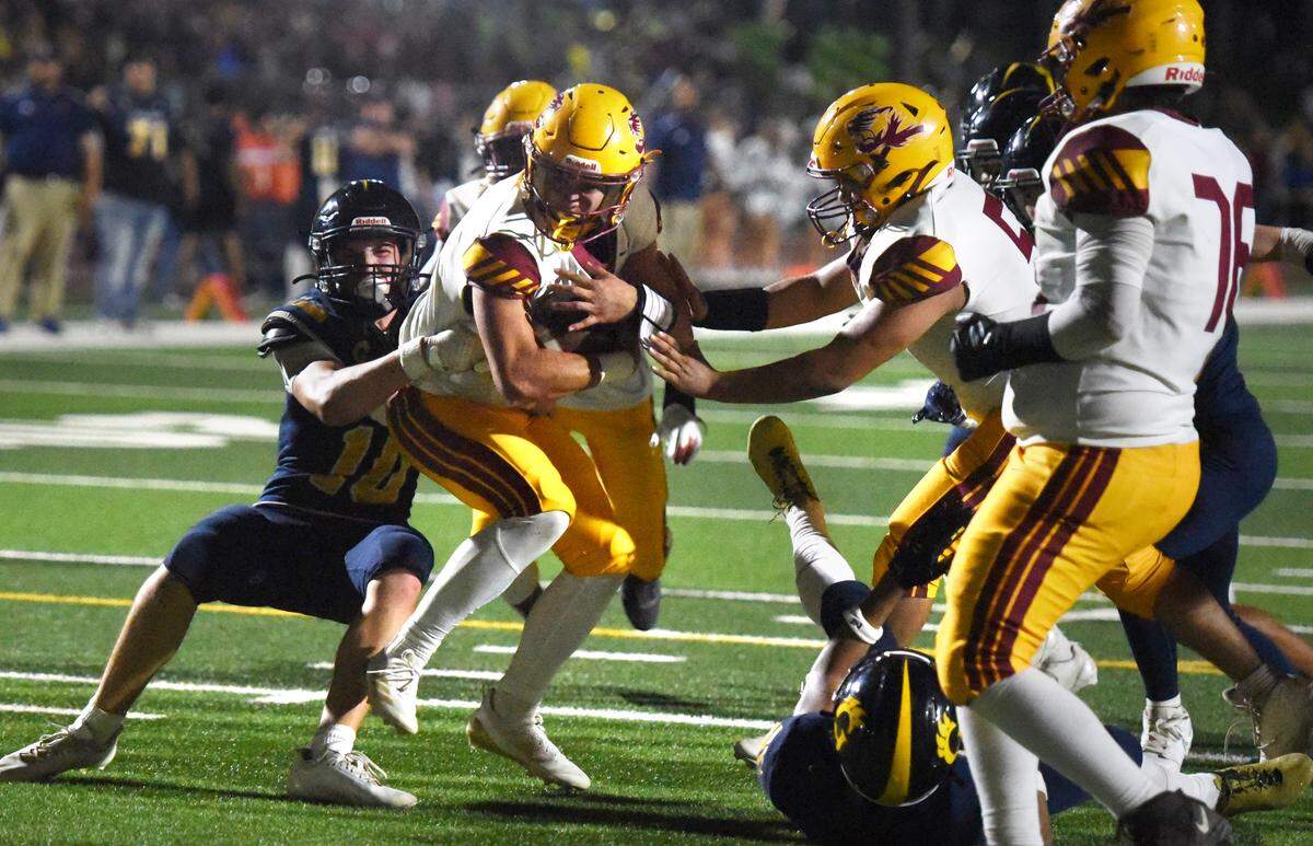 Los Banos quarterback Gavin Blackwood-Estrada fights to score before the end of the first half, but is stopped by Gregori's defensive front in the game in Modesto, Friday, Sept. 19, 2025.  