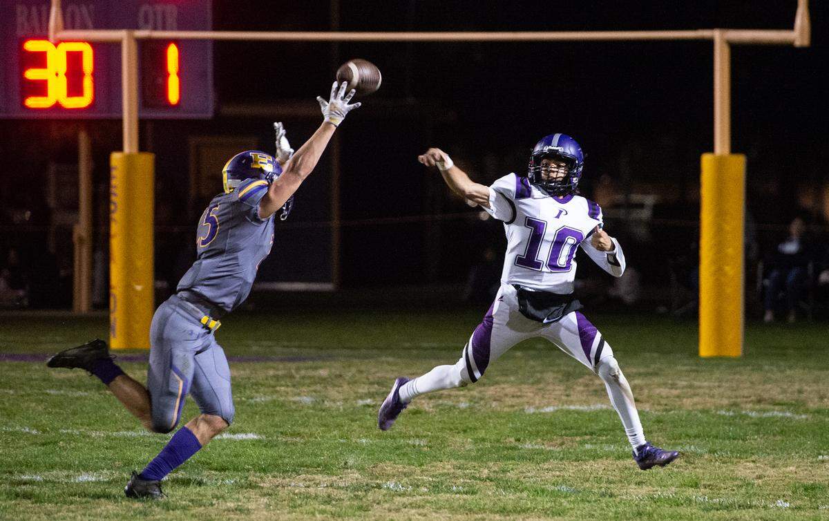 Escalon’s Ayden Wilson chases Pacheco quarterback Aiden Huerta during the first round playoff game in Escalon, Calif., Friday, Nov. 4, 2022.