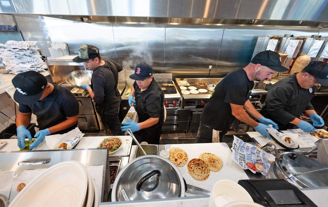 Staff prepares food for guests during the grand opening of Nick the Greek restaurant in Riverbank, Calif., Tuesday, September 12, 2023.