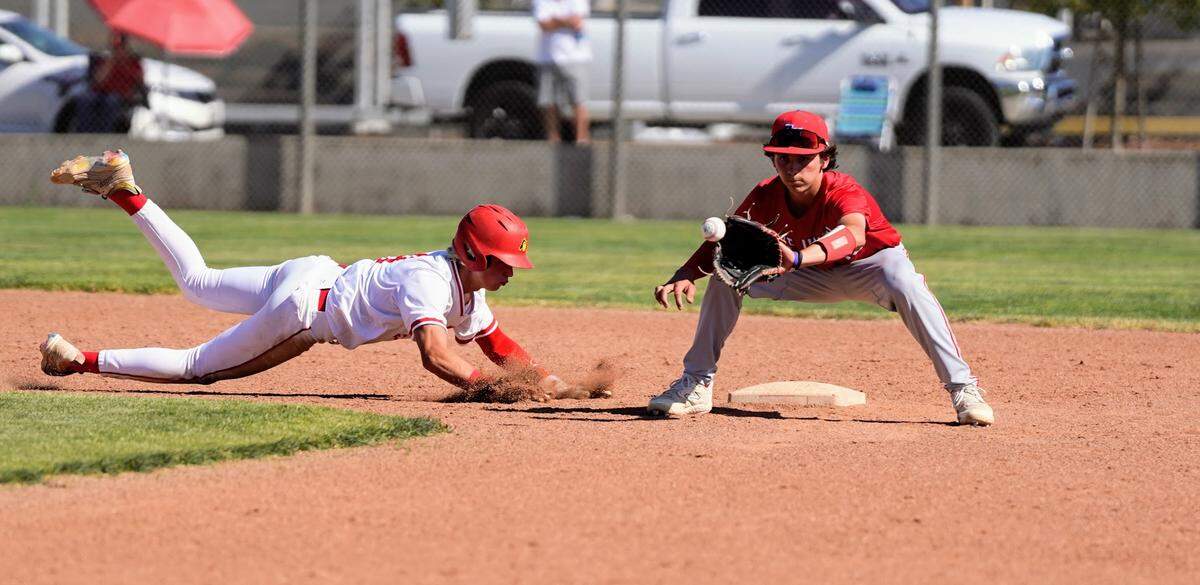 Oakdale’s Peyton Wallace slides back to second base to avoid an out during the Sac-Joaquin Section Division IV baseball quarterfinals against East Union at Oakdale High School on Friday, May 9, 2025.