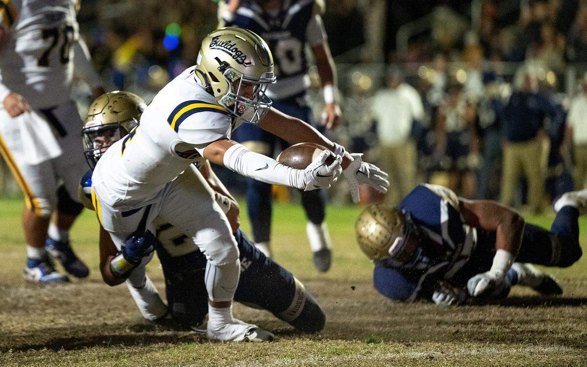 Turlock’s Joseph Delte (4) scores a touchdown on a run during the Sac-Joaquin Section Division I playoff game with Central Catholic at Central Catholic High School in Modesto, Friday, Nov. 15, 2024.