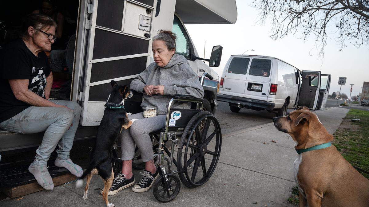 Sheryl Bremen and her daughter Tiffany Rasnic are living in their RV with their dogs Girlfriend and Gus at Broadway Park in Turlock, Calif., on Wednesday, Feb. 9, 2022. Bremen is hoping to move into a home and continue to care for her daughter who lost her sight several years ago.