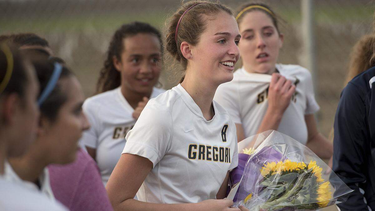 Gregori defender Katie Molthen receives flowers from the Enochs players after the Modesto Metro Conference game with Enochs in Salida on Friday, Jan. 26, 2018. Molthen's father, Luke, who was the assistant Jaguars coach, died Tuesday of a heart attack.