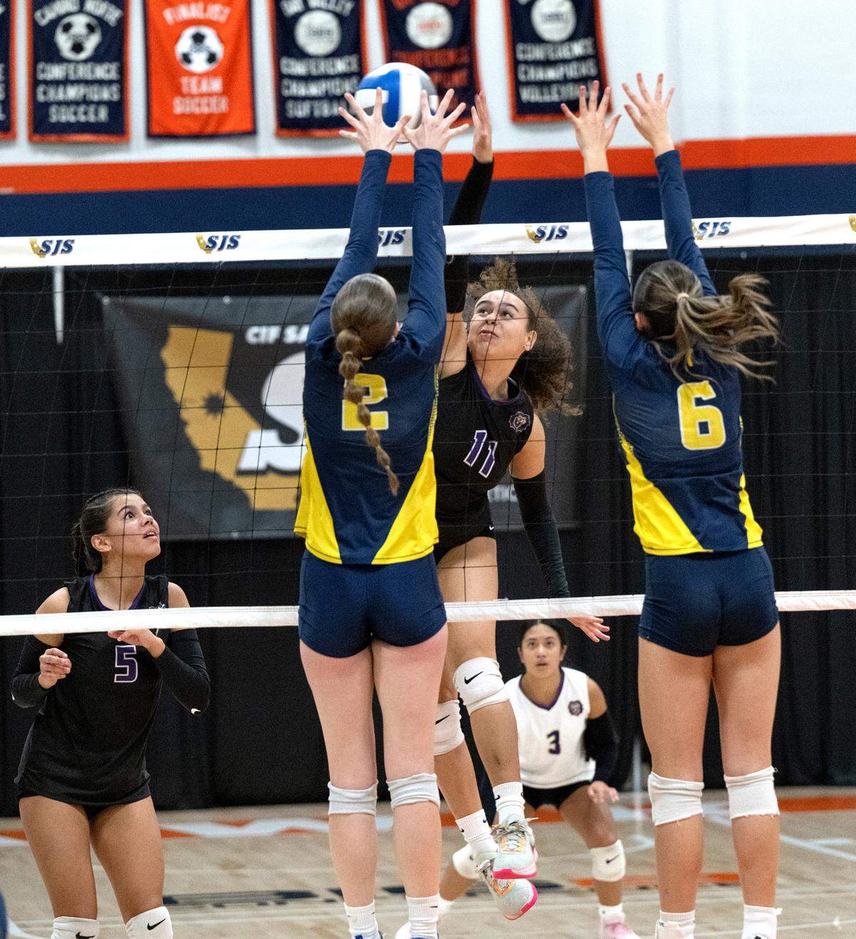 Bradshaw Christian’s Chloe Lester and Big Valley Christian defenders Jordan Beers (2) and Claire Medhurst (6) battle at the net during the Sac-Joaquin Section Division 5 championship match with Big Valley Christian at Cosumnes River College in Sacramento, Saturday, Nov. 9, 2024.