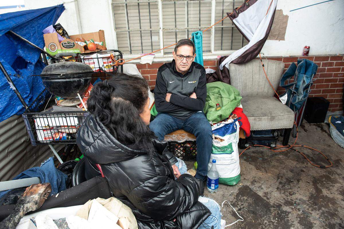 Modesto Councilmember Nick Bavaro talks with homeless resident Denise Picanso in the airport neighborhood on  March 29, 2023.