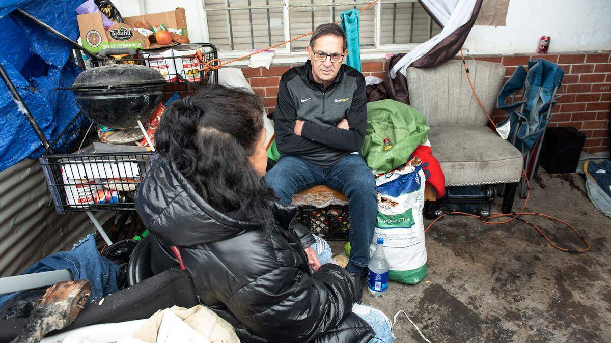 Modesto Councilman Nick Bavaro talks with homeless resident Denise Picanso in the airport neighborhood in Modesto, Calif., on Wednesday, March 29, 2023.